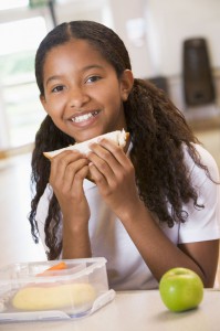 picture of african american girl eating healthy lunch